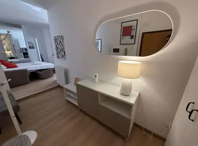 a living room with a table and a mirror at Colosseo Licia Apartment in Rome