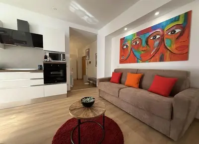 a living room with a couch and a painting on the wall at Colosseo Licia Apartment in Rome