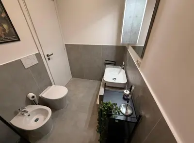 a small bathroom with a sink and a toilet at Colosseo Licia Apartment in Rome