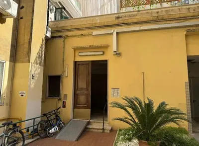 a yellow building with bikes parked outside of it at Colosseo Licia Apartment in Rome