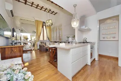a kitchen with a white island in a room at Vicolo Savelli Luxury Suites in Rome