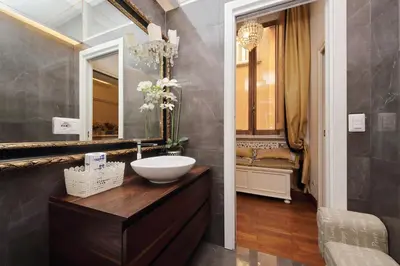 a bathroom with a sink and a mirror at Vicolo Savelli Luxury Suites in Rome