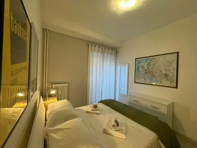 a hotel room with a bed and a map on the wall at Urban Oasis Near Appia Antica Park in Rome