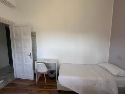 a bedroom with a bed and a table and a chair at Green Park San Pancrazio in Rome