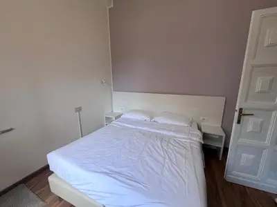 a bedroom with a white bed with two pillows at Green Park San Pancrazio in Rome