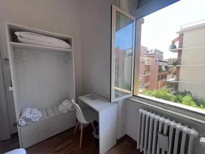 a small room with a desk and a window at Green Park San Pancrazio in Rome