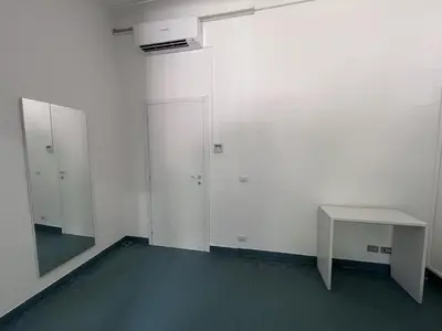 an empty room with a table and a white wall at Green Park San Pancrazio in Rome