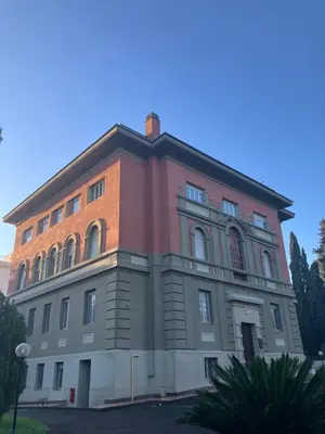 a large brick building with a red at Green Park San Pancrazio in Rome