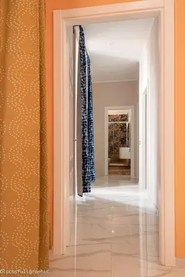 a hallway with orange walls and blue curtains at Sophie's choice 3 e Sophie's choice 4 in Rome