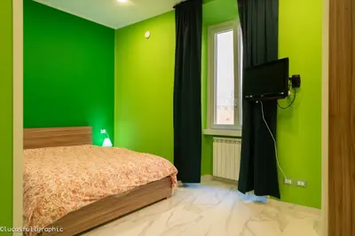 a green bedroom with a bed and a television at Sophie's choice 3 e Sophie's choice 4 in Rome