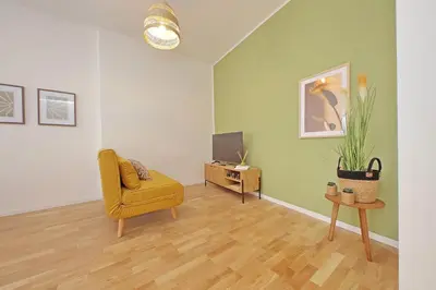 a living room with a yellow chair and a television at Nature Flat in Rome