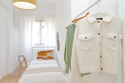 a white room with a shelf with a white coat at Nature Flat in Rome