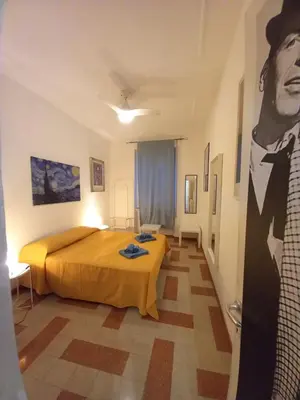 a bedroom with a bed and a painting of a man at Camera vista San Pietro in Rome