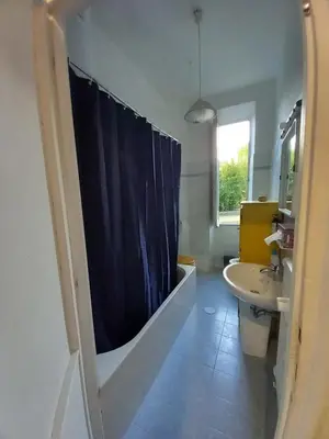 a bathroom with a blue shower curtain and a sink at Camera vista San Pietro in Rome