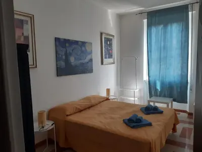 a bedroom with a bed with two blue towels on it at Camera vista San Pietro in Rome
