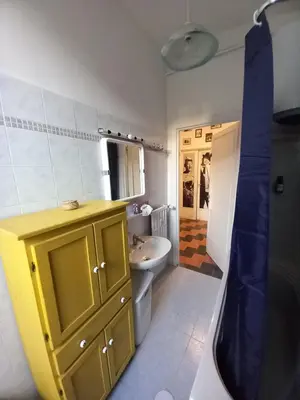a bathroom with a yellow cabinet and a sink at Camera vista San Pietro in Rome