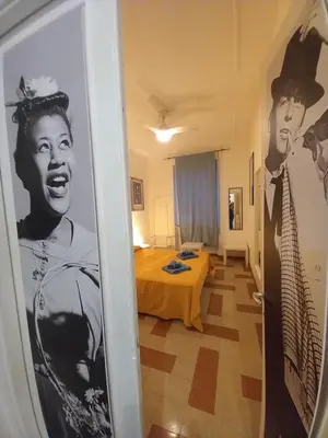 a room with a bed and a picture of a man at Camera vista San Pietro in Rome