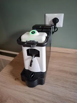 a white coffee maker sitting on a wooden table at Gardenie House in Rome