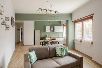 a living room with a couch and a kitchen at Gardenie House in Rome