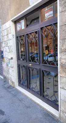 a store front door with glass windows on a building at Gardenie House in Rome