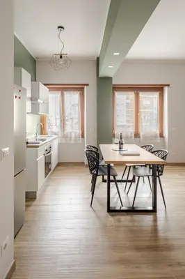 a kitchen and dining room with a table and chairs at Gardenie House in Rome