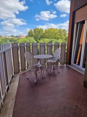a patio with a table and chairs on a balcony at casa a PortaPortese in Rome