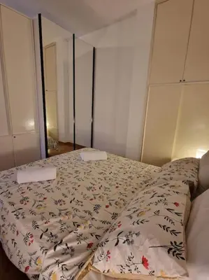 a bedroom with a bed with a comforter on it at casa a PortaPortese in Rome