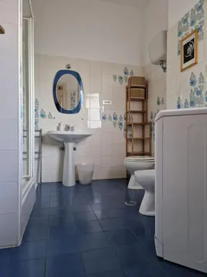 a bathroom with a sink and two toilets at casa a PortaPortese in Rome