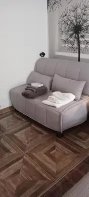 a couch in a living room with a wooden floor at Roma ,casa san Paolo in Rome