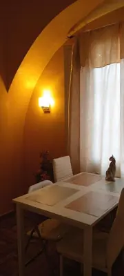 a table and chairs in a room with a window at Roma ,casa san Paolo in Rome