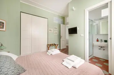 a bedroom with a bed with towels on it at Iside Apt at Colosseum -2 bedrooms 2 bathrooms in Rome
