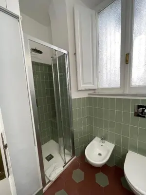 a bathroom with a shower and a toilet and a sink at Iside Apt at Colosseum -2 bedrooms 2 bathrooms in Rome