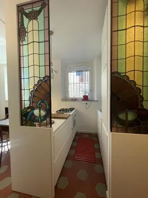 a kitchen with stained glass windows on the walls at Iside Apt at Colosseum -2 bedrooms 2 bathrooms in Rome