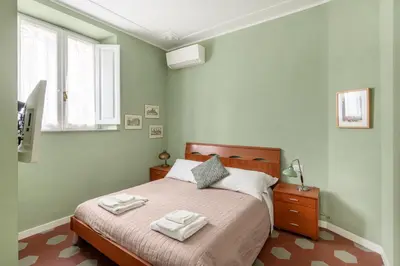 a bedroom with a bed with two towels on it at Iside Apt at Colosseum -2 bedrooms 2 bathrooms in Rome