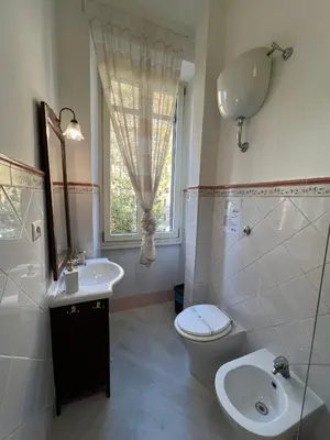 a bathroom with a sink and a toilet and a window at Maison Trionfale a 2 passi dal Vaticano in Rome