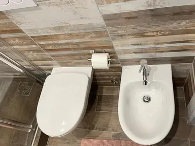 a bathroom with a toilet and a sink at Casa Dà! in Rome
