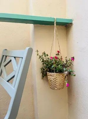 a basket with flowers hanging on a wall at Casa Dà! in Rome