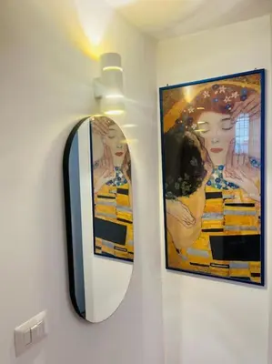 a mirror on a wall with a picture of a woman at Casa Dà! in Rome