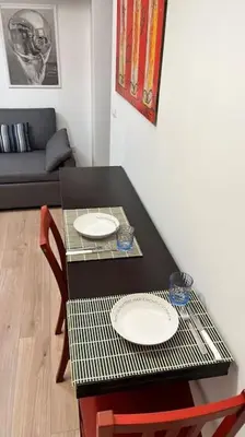 a black table with two plates on it in a living room at Casa Dà! in Rome