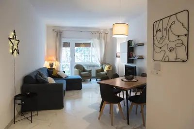 a living room with a blue couch and a table at Casa Eva - Roma in Rome