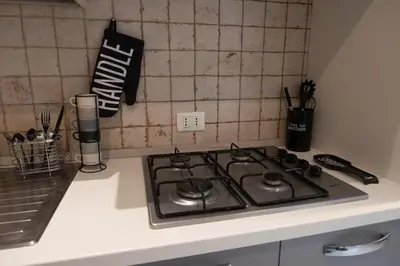 a stove top oven sitting on top of a kitchen counter at Casa Eva - Roma in Rome