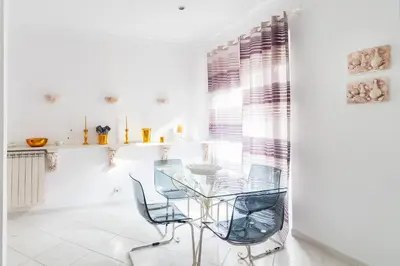 a dining room with a glass table and two chairs at Veneto Excelsior Suite in Rome