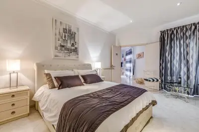 a bedroom with a large bed and a window at Veneto Excelsior Suite in Rome