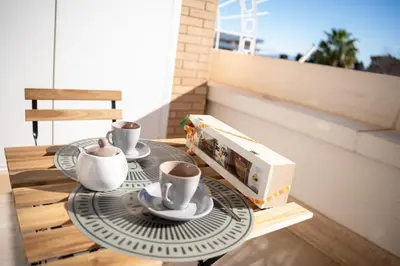 a table with two coffee cups and a microwave at Aurelia Vatican City Apartment in Rome