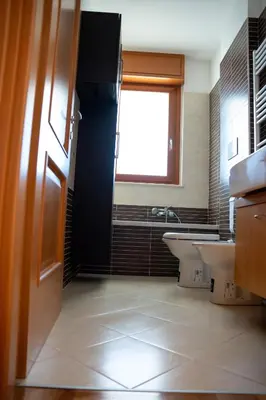 a bathroom with two sinks and a tub and a window at Aurelia Vatican City Apartment in Rome