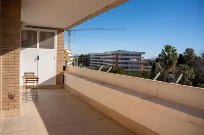 a balcony with a table and a chair on a building at Aurelia Vatican City Apartment in Rome