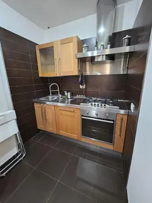 a kitchen with a stove and a sink at St Peter central apartment in Rome