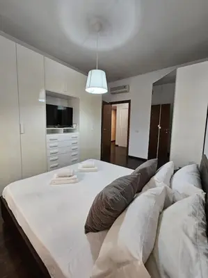 a bedroom with a large white bed with pillows at St Peter central apartment in Rome