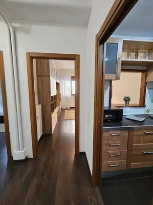 a room with a kitchen with a counter and a hallway at St Peter central apartment in Rome