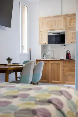 a kitchen with a table and chairs in a room at BeB Domus Arbenzio San Giovanni Suite in Rome